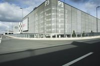 the empty parking lot with a large glass building in the background that says psp