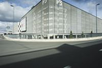 the empty parking lot with a large glass building in the background that says psp