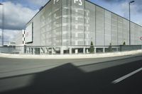 the empty parking lot with a large glass building in the background that says psp