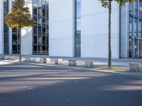 there is an empty parking area next to the building as seen from a side view