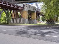 a motorcyclist is under an overpass in the middle of a street