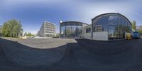 the camera takes a shot of an empty parking lot where the street is filled with buildings