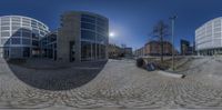 a full - view photo of a sphere photograph taken on a street corner with three buildings