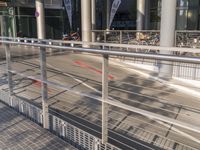 a building with steel railing and outdoor walkway with bike racks attached to the railing outside