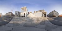 a fish eye lens lens view of a building with a staircase in the background, and a parking lot in front