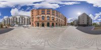 360 - shot image of an outdoor city square with buildings and traffic lights showing street