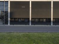 a man is riding his bike on a street past an empty parking lot with stairs