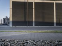 a motorcycle is parked outside a building near rocks and grass below the road side windows