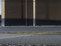 a motorcycle is parked outside a building near rocks and grass below the road side windows