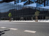 an empty road with trees and some building in the background of the picture in front