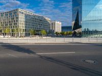 a building and a road are in front of it on a sunny day with some clouds