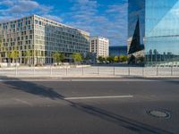 a building and a road are in front of it on a sunny day with some clouds