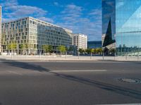 a building and a road are in front of it on a sunny day with some clouds