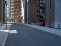 a road through which is a large modern building with an awning over it's entrance