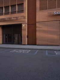 street in front of a large building with wooden sidinged doors and sign saying salmonon bagel