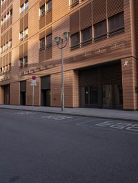 street in front of a large building with wooden sidinged doors and sign saying salmonon bagel