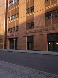 street in front of a large building with wooden sidinged doors and sign saying salmonon bagel