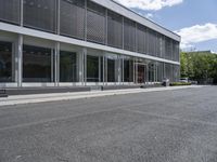 a view of a parking space in front of a building with an open roof and no parking