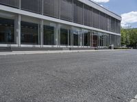 a view of a parking space in front of a building with an open roof and no parking