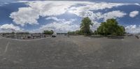 a street scene with a circular fish eye lens view of an empty parking lot with parked cars