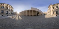 this is an 360 - eye picture of a circular building in a square area of stone