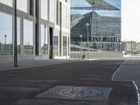 the street has an old manhole with a lot of glass windows on it and many street spaces