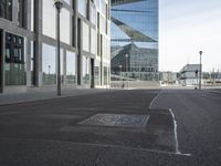 the street has an old manhole with a lot of glass windows on it and many street spaces