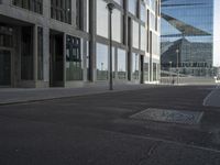 the street has an old manhole with a lot of glass windows on it and many street spaces