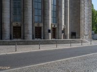 an entrance of a building with large columns and doors that spell out the word voltege