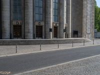 an entrance of a building with large columns and doors that spell out the word voltege