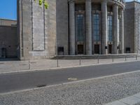 an entrance of a building with large columns and doors that spell out the word voltege