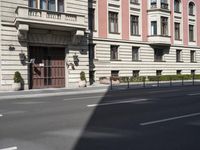 a view of the building on a clear day with no clouds in the sky and no cars in the street