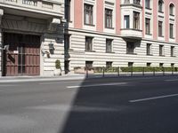 a view of the building on a clear day with no clouds in the sky and no cars in the street