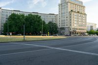 a view from an intersection at a bus stop in front of a hotel and other buildings