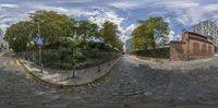 the street has been made to look like cobblestones and there are some plants on the side of the street