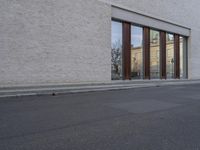 this is an image of a building with many windows and doors as well as a dog that is standing in the road