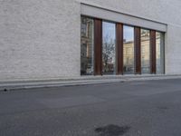 this is an image of a building with many windows and doors as well as a dog that is standing in the road