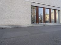 this is an image of a building with many windows and doors as well as a dog that is standing in the road