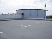 a boat is parked in an empty parking lot near an air port on the water