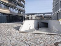 a street with the entrance to a tunnel for pedestrians to walk under on top of it