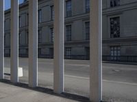 a skate board is in front of some concrete columns on the side of the road