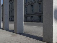 a skate board is in front of some concrete columns on the side of the road