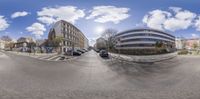 the view from the street with cars parked on the side of a road and buildings