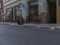 a large long sidewalk with tables and a sign on it's side of the street