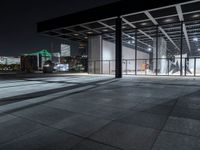 a large building on a dark day with no clouds in the sky at night and the ground is stone