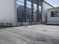 an empty building with some white windows and no one on it in front of it