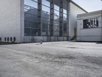 an empty building with some white windows and no one on it in front of it