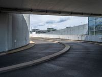 a car is driving on the highway through an underground parking garage area in a city