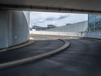 a car is driving on the highway through an underground parking garage area in a city