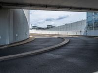 a car is driving on the highway through an underground parking garage area in a city